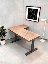 Load image into Gallery viewer, Solid wood L-shaped standing desk with natural rubberwood top and black steel legs in a home study corner