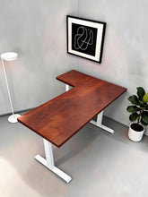 Load image into Gallery viewer, Solid wood L-shaped standing desk with walnut-finish top and white steel legs in a room corner