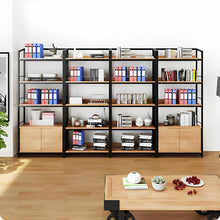 Load image into Gallery viewer, Bookshelf with books and office supplies in a room with a desk and plant.