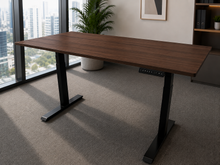 Load image into Gallery viewer, Walnut Finish rubberwood adjustable study table with black legs in an office with a city view