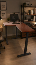 Load image into Gallery viewer, Side view of the L-shaped standing desk showing the 4 cm walnut-finish top and black steel legs