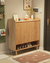 Load image into Gallery viewer, Natural wood wooden shoe cabinet with three doors and shoes on the open base shelf