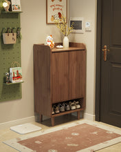 Load image into Gallery viewer, Two-door wooden shoe cabinet in black walnut beside a dark front door