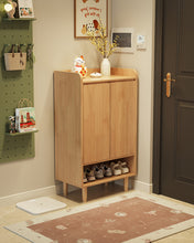 Load image into Gallery viewer, Two-door wooden shoe cabinet in natural wood with shoes on the open base shelf