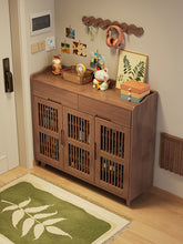 Load image into Gallery viewer, Slatted-door ventilated shoe cabinet in black walnut, 120cm drawer model in an entryway