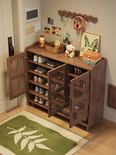 Load image into Gallery viewer, Ventilated shoe cabinet with slatted doors open showing shoes on internal shelves